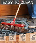 Person sweeping Rugged Heavy Duty Rectangle Entry Door Mat 24 X 36 Inches For High Traffic Front Porch, Non Slip Rubber Back.
