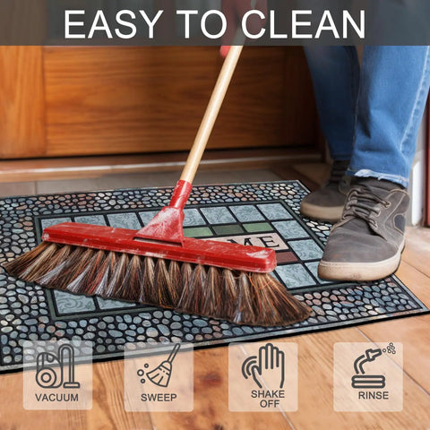Person sweeping Rugged Heavy Duty Rectangle Entry Door Mat 24 X 36 Inches For High Traffic Front Porch, Non Slip Rubber Back.