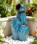 Outdoor Ceramic Water Fountain With 4 Tier Pots Turquoise Ocean Wave Texture 29 Inch Garden Centerpiece For Patio Yard Or Porch Creates A Relaxing Serene Oasis With Dynamic Waterfalls installed in a garden surrounded by flowers and stones.