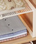 Closet Shelf Organizer Metal Storage Rack for home wardrobes showing folded linens on iron frame for space saving.