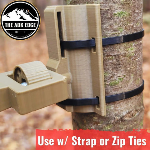 Universal Trail Camera Mount With Standard Camera Thread And 360 Degree Leveling Plus 180 Degree Tilt No Sweat Strap Rig For Tough Hunts And Wildlife Photography Outdoors Gear mounted on a tree using zip ties.