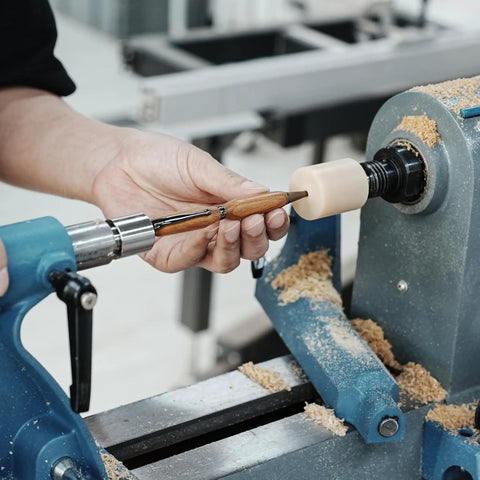 Using Pen Press Kit For Woodturning Lathes With 2MT Taper for precise pen making and assembly on lathe with yellow pad.
