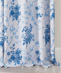 Close-up view of blue floral 100 percent blackout curtains in a rose pattern with grommet top, 84 inches long, OEKO-TEX certified.