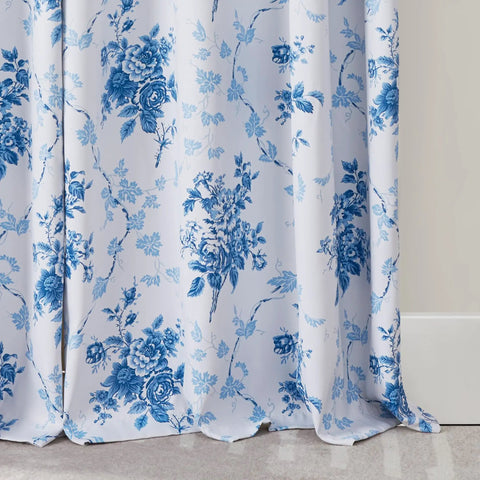 Close-up view of blue floral 100 percent blackout curtains in a rose pattern with grommet top, 84 inches long, OEKO-TEX certified.