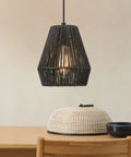 7 Inch Handwoven Rattan Pendant Light With Matte Black Basket Shade in cozy dining setting