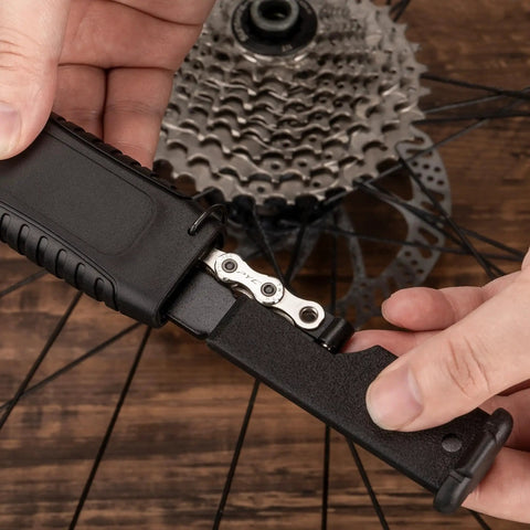 User operating Two In One Chain Whip And Lockring Tool For Cassettes The Ultimate Bike Maintenance Kit on bicycle wheel cassette