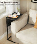 C Shaped End Table With Sliding Tray Under Sofa 28 Inch High Side Table With Storage Bag Black next to cream sofa and window