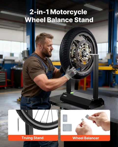 Man using motorcycle wheel balancer and truing stand with adjustable centering cones and truing pointer in workshop.