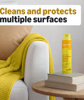 Straight Up Fresh Lemon Furniture Polish Spray That Cuts Through Grime Cleans Hard And Shields Sealed Wood Leather Granite For A Slick Superb Finish With Zero Waxy Buildup In Every Bottle on a table with books and a cozy blanket.