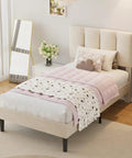 Twin Size Bed Frame Featuring Extra Thick Velvet Upholstered Headboard And Heavy Duty Hardwood Slats Pale Beige Platform mattress base with pink bedding.