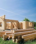 Log cabin under construction with timber logs on ground, strong-drive timber screws used for fastening.