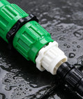 Ultimate 2026 Expandable Garden Hose Repair Kit Features Universal Female And Male Connectors That Fix Leaky Hoses In Minutes For Most 3/4 Or 5/8 Inch Water Lines Up To 100 FT Including Retractables And Plastic Models Perfect Green Solution. Green ABS plastic hose repair connector with white and black fittings, wet on surface
