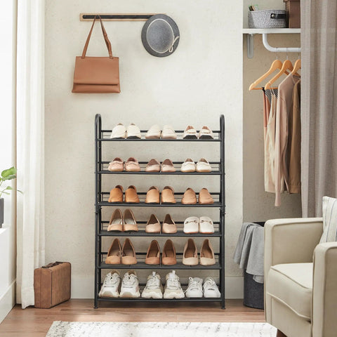 Sturdy 3 Tier Shoe Organizer Rack For Closet And Entryway, Holds 12 pairs, metal shoe shelf, black, in use by front door.