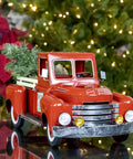 Red Metal Christmas Pickup Truck Outdoor Decor With Tree In Bed Totally Lit Powder Coated Weatherproof Metal Construction 18 Inch Long Yard Ornament For Patio Garden And Holiday Festive Vibes, on a reflective surface with festive lights