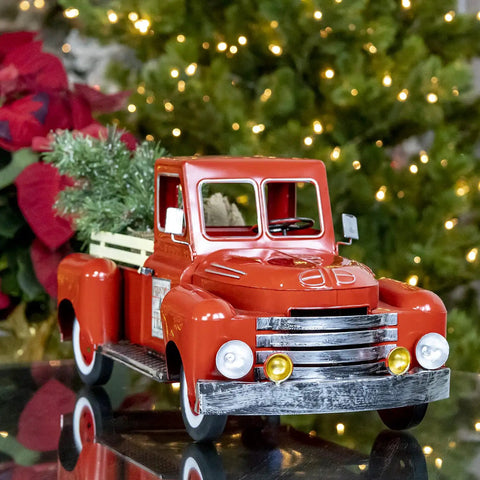 Red Metal Christmas Pickup Truck Outdoor Decor With Tree In Bed Totally Lit Powder Coated Weatherproof Metal Construction 18 Inch Long Yard Ornament For Patio Garden And Holiday Festive Vibes, on a reflective surface with festive lights