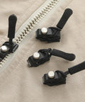 Zipper Pull Repair Kit For Clothing Backpacks Tents And Outdoor Gear Durable Black Plastomer Pulls shown on beige fabric