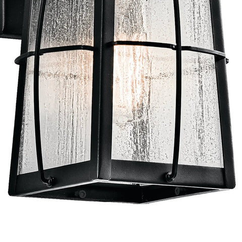 Close-up of Tolerand 12 Inch Outdoor Wall Light In Textured Black With Clear Seeded Glass 1 Light Exterior Sconce For Porch And Patio