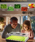 Man and child using Seed Starter Tray With Full Spectrum LED Grow Light, 54-Cell Kit With Humidity Dome on a table