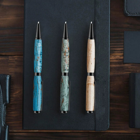 Colarr 7mm slimline wooden pen set: three pens with black tips in blue, green, and natural finishes on a notebook