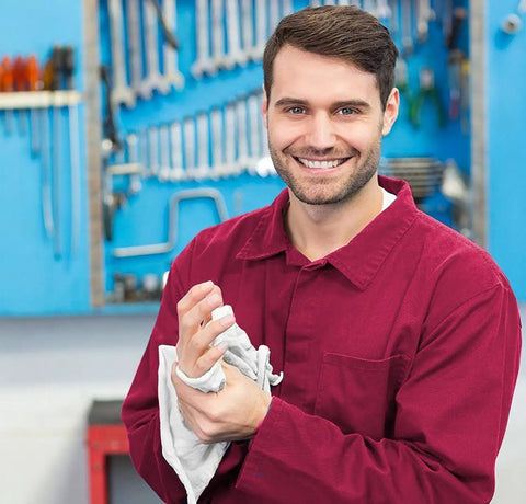 Man in red shirt using Cotton Shop Towels 14 By 12 Inches 145 Pack Reusable Cleaning Rags For Automotive Garage Workshop And Industrial Use