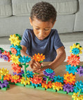 Child playing with 101 Piece Gear Building Set For Kids So They Can Build Twisting Gardens While Learning Cause Effect Sequencing And Early Engineering Hands On STEM Construction Toy Montessori Inspired Kid Friendly Fine Motor Play And Educational Engineering Gift