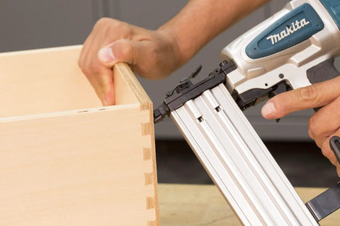 Rock Solid 18 Gauge 2 Inch Brad Nailer Kit in use, demonstrating precise fastening on a wood drawer joint.