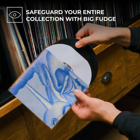 Person placing a vinyl record into a clear 50 pack 7 inch vinyl record outer sleeve 3 mil thick wrinkle free polypropylene ultra transparent cover.