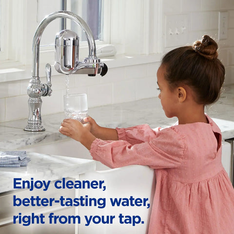 Child using the Lead Reducing Faucet Mount Water Filter For Your Sink Easy Install Great Tasting Water Save Money Ditch Bottled Water 100 Gallon Filter Life Chrome Finish Compatible With Sinks With External Aerators, pouring water into a glass at the sink.