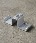 Heavy Duty Galvanized Saddle Clips For Steel Grating make your industrial walkways safe with carbon steel clamps resting on concrete.