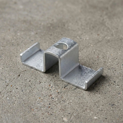Heavy Duty Galvanized Saddle Clips For Steel Grating make your industrial walkways safe with carbon steel clamps resting on concrete.