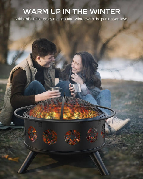 Couple warming up by 32 Inch Fire Pit With BBQ Grill And Mesh Cover For Outdoor Patio Backyard Bonfires with pentagram design.