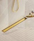 Gold 28 Inch Linear Shower Drain With 2 In 1 Flat And Tile Insert Cover Stainless Steel Brushed Brass in modern bathroom setting