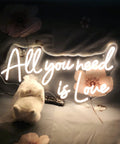 Love Neon Sign LED Neon Light For Wall Decor Warm White Glow with "All you need is Love" text on floral background, 22 x 11.9 inch