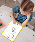 Child using 12 Pack Double Sided Whiteboards 9x12 Inches For Math Practice Long Division Dry Erase Lapboards at a school desk
