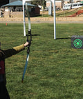 Child aiming at All-Side 16x18 Archery Target Block for Outdoor Practice on grass field, clear view of target with arrows, Black