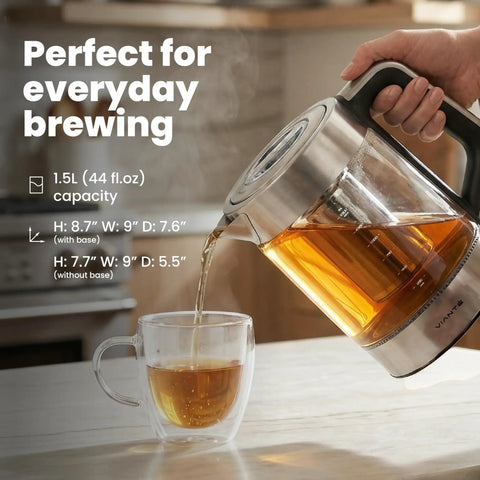 Electric Tea Kettle With Infuser For Loose Leaf Tea No Plastic Touching Water Temperature Control Automatic Shut Off 1.5L Borosilicate Glass Hot Tea Maker pouring tea into cup on kitchen counter.