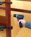 Person using the 12V Max EC Brushless 3/8 Inch Drill Driver Bare Tool With Pro Torque 300 In-Lbs to drill into wooden cabinets.