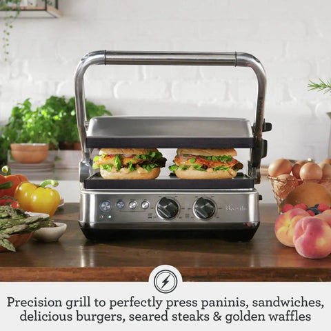 Breville Stainless Steel Electric Grill Panini Maker With One Touch Presets for burgers and sandwiches on compact countertop.
