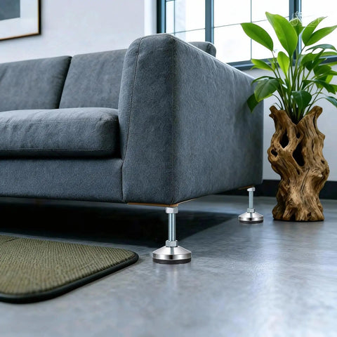 Four Pack Heavy Duty Adjustable Leveling Feet With Anti Vibration Pads under a sofa on a polished floor