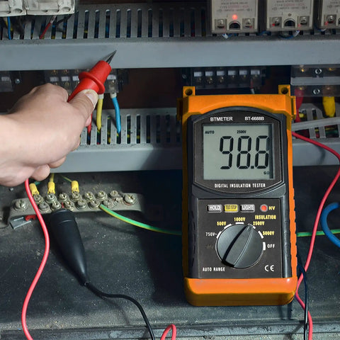 Megohmmeter Insulation Resistance Tester with auto ranging and backlit display in use on an electrical panel