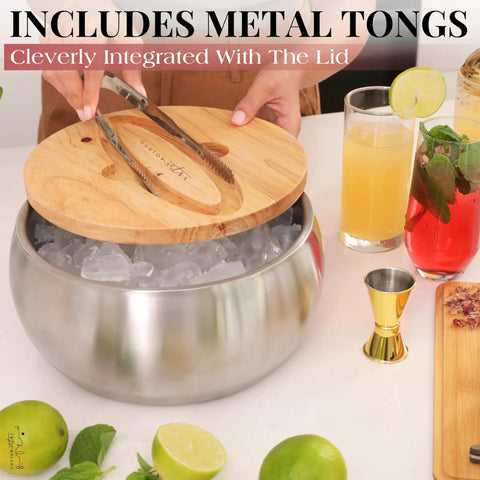 Large Double Wall Stainless Steel Ice Bucket With Lid And Tongs Bpa Free Drink Cooler with ice and cocktails on a table.