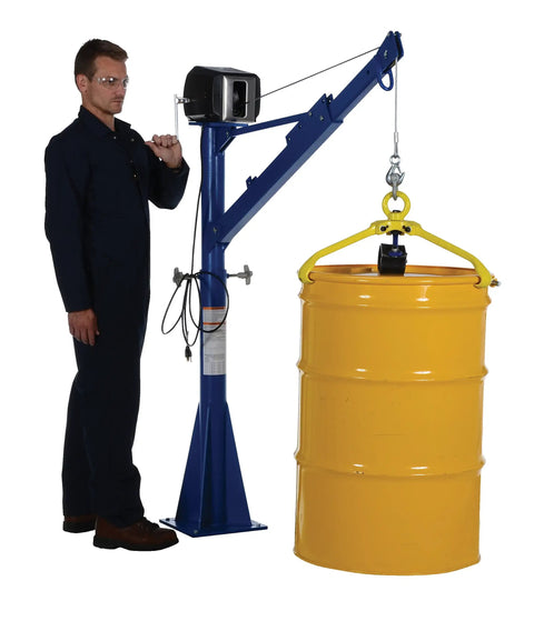 Built Like A Tank Freestanding AC Powered Jib Crane Features Heavy Duty Steel Frame And Smooth Electric Winch For Lifting Up To 1500 Lbs With Twenty Five Foot Cable For Warehouse Jobs lifting a yellow barrel.