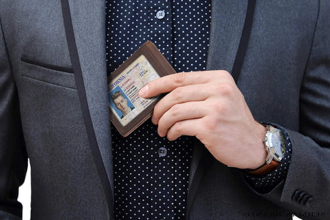 Man holding a Slim RFID Blocking Bifold Wallet For Men With Money Clip, Genuine Leather, Minimalist Front Pocket Design in Texas Brown.