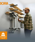 Heavy Duty Four Tier Lumber Storage Rack For Garage And Workshop Space Saving Metal Board Shelf For Plywood Pipes And Building Materials White Gray mounted on wall with lumber.