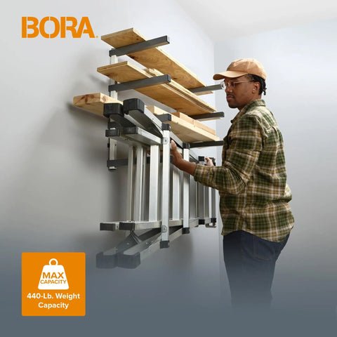 Heavy Duty Four Tier Lumber Storage Rack For Garage And Workshop Space Saving Metal Board Shelf For Plywood Pipes And Building Materials White Gray mounted on wall with lumber.