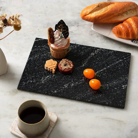 Natural Black Marble Cutting Board 12 By 8 Inch Real Stone Slab For Kitchen Counter And Cheese Board Elegant Marble Serving Tray For Appetizers Decor Or Barware Display with assorted appetizers on marble table.