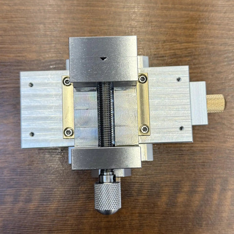 Heavy Duty Cross Slide Table With Integrated Vice And Buttery Smooth Micro Tuning Xy Linear Module top view showing aluminum and brass components.
