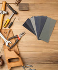 56 Piece Wet And Dry Sanding Sheets Kit With Assorted Grit 400 To 5000 for Wood and Metal displayed on wood surface with tools