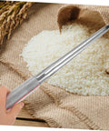 Person using Stainless Steel Grain Sampler With Rubber Handle Portable Fertilizer Probe For Accurate Wheat Seed And Soil Sampling Durable Farm And Laboratory Use over rice pile