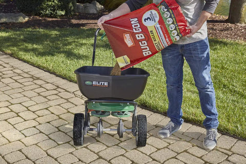 Person pouring All In One Lawn Insect Killer into a lawn spreader, effective on ants, fleas, ticks, and more for up to 3 months.